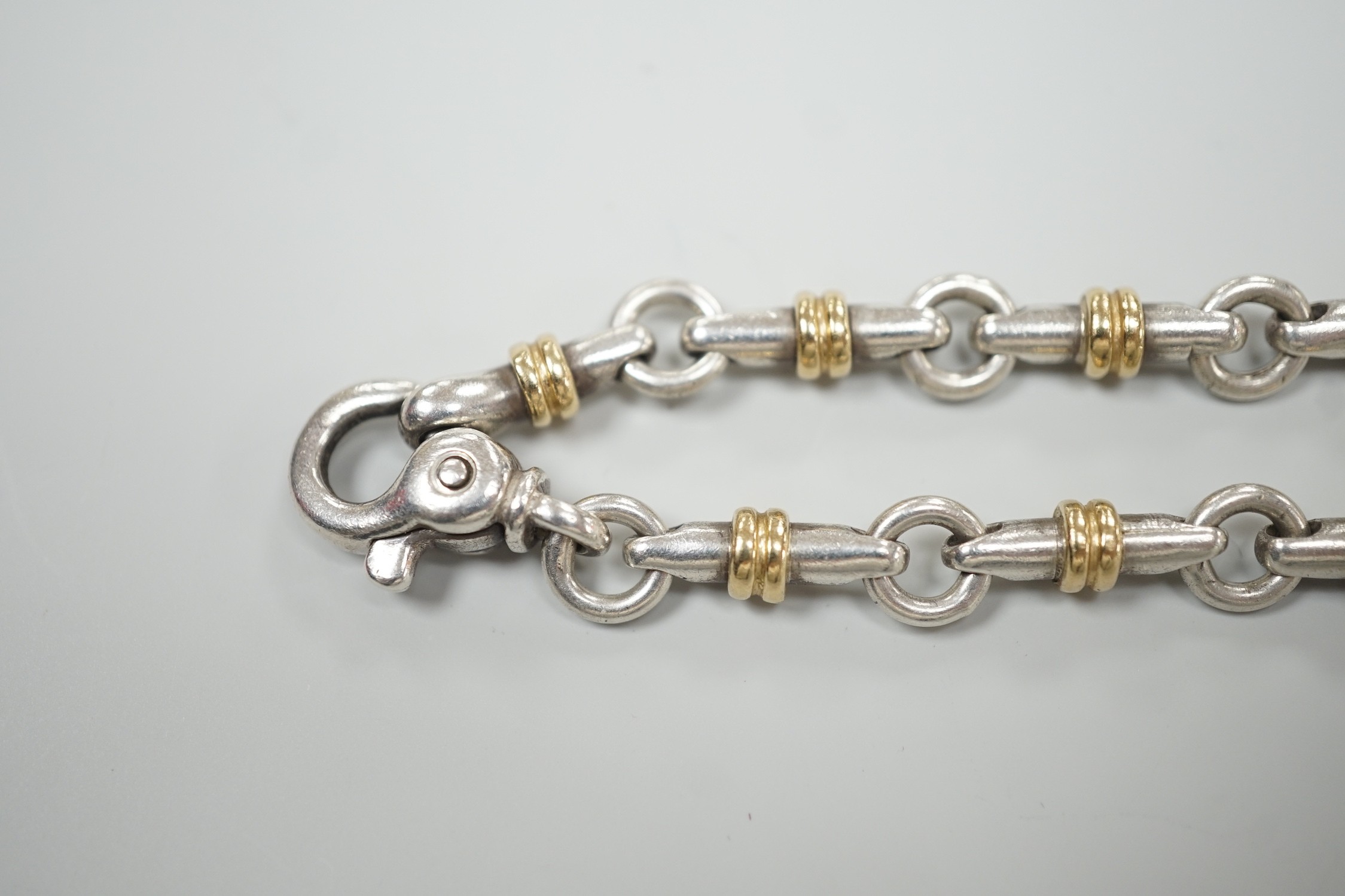 A modern Italian Tiffany & Co 750 yellow metal and 925 white metal, circular and baton link bracelet, 18cm.